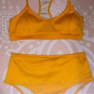 Orange high waisted bathing suit with a pretty ribbed pattern.